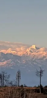 Snow-capped mountain peaks with a vibrant sunrise sky.