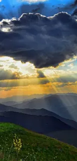 Sunrise over mountains with dramatic sky and green hills.