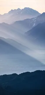 Serene mountain sunrise capturing ethereal light over distant peaks.