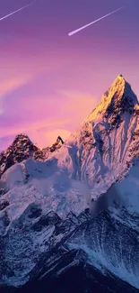 A stunning sunset over a snow-capped mountain with a pink and purple sky.