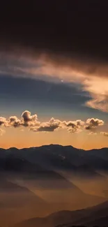 Beautiful sunset over mountains with dramatic clouds.