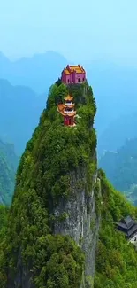 Temple on a lush green mountain with misty horizon.