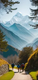 Hikers on a mountain path with a stunning backdrop of snow-capped peaks.