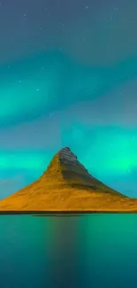 Vibrant aurora borealis over a scenic mountain with reflection.