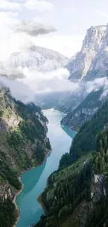 Breathtaking view of a river through lush green mountains and peaks, perfect for wallpapers.