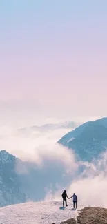 Couple standing on a snowy mountain under a pastel pink and blue sky.