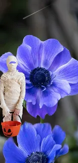 Mummy with pumpkin bucket near purple flowers.