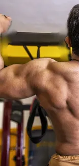 Muscular man exercising in a gym, showcasing his strong back.