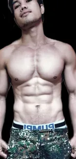 Muscular male torso on black background.