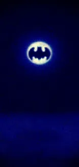 Night sky with Batman signal glowing brightly.