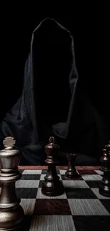 Dark hooded figure and chess setup on a board.