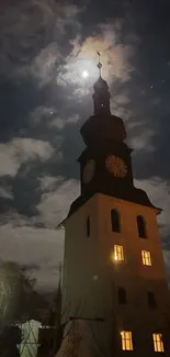 A clock tower illuminated by moonlight in a serene night sky.