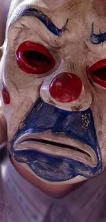 Close-up of a colorful clown mask on a mobile wallpaper.