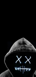 Dark hooded figure with LED mask on black background.