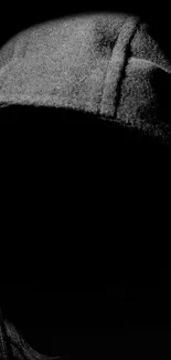 Dark hooded silhouette on black background.