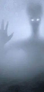 Mysterious foggy wallpaper with spectral figure and glowing eyes.