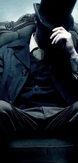 Mysterious gentleman in dark suit and top hat sitting on a chair.