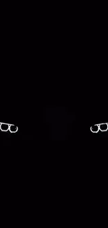 Mysterious glowing glasses on black background.