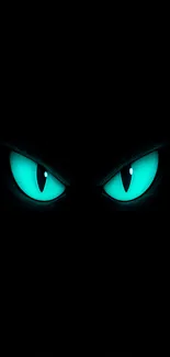 Glowing teal eyes on a dark background wallpaper.
