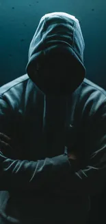 Mysterious hooded figure in dark shadows with teal background.