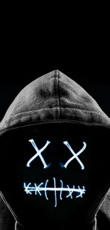 Hooded figure with neon glowing face in dark background wallpaper.