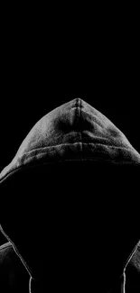 Mysterious hooded figure on a black background for mobile wallpaper.