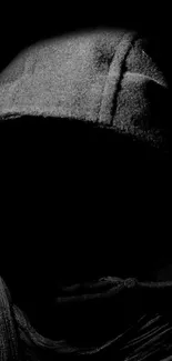 Mysterious hooded figure in darkness wallpaper.