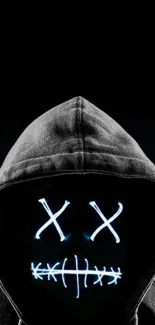 Hooded figure with neon face on a dark background.