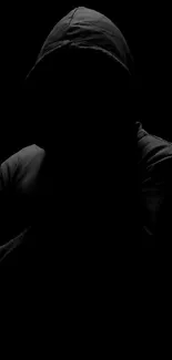 A dark, hooded silhouette on a black background wallpaper.