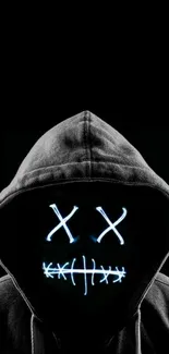 Mysterious hooded figure with glowing mask on a dark background.