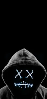 Hooded figure with LED mask on black background.
