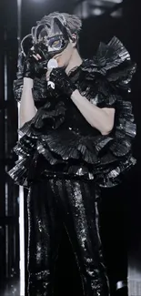 Masked performer with black ruffled attire.