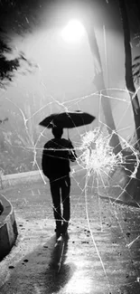 Silhouetted figure with umbrella on a dark pathway.