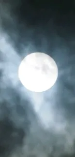 A mystical full moon glowing in a cloudy night sky.