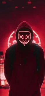 Hooded figure with neon lights on a red background.