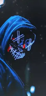 Hooded figure with neon mask in the dark, featuring glowing blue and red lights.