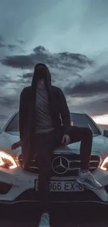 Hooded figure on a luxury car with a cloudy night sky backdrop.