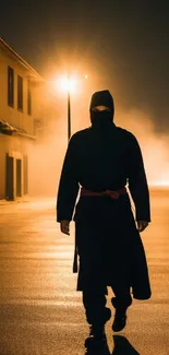 A masked ninja in black robes walks down a foggy, dimly-lit street at night.