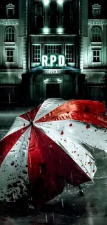 Red and white umbrella in front of RPD building at night.