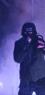 Masked performer in purple light on stage.