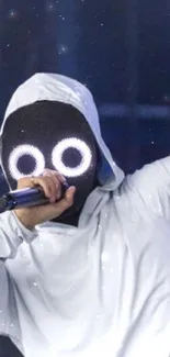 Mysterious performer in white hoodie with glowing eyes holding a microphone.