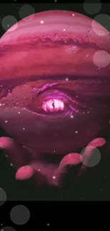 Surreal pink planet held by a hand in space-themed wallpaper.