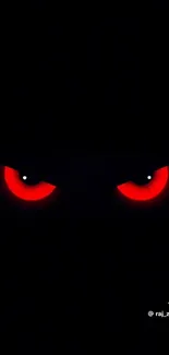 Wallpaper with intense red eyes in darkness.