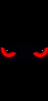 Mysterious glowing red eyes in darkness.