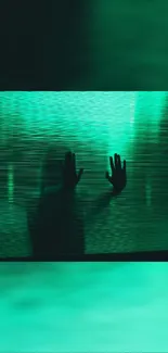 Silhouette with hands against a glowing green textured backdrop.