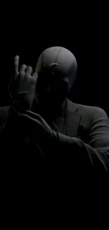 Mystery silhouette in dark suit with black background.