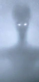Mysterious silhouette with glowing eyes in misty background.