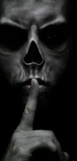 Eerie skull face with a finger gesture on dark background.