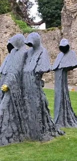 Hooded stone figures in a historic garden setting.