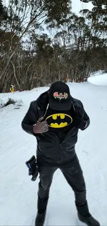 Person in leather jacket reveals superhero logo in snowy forest.